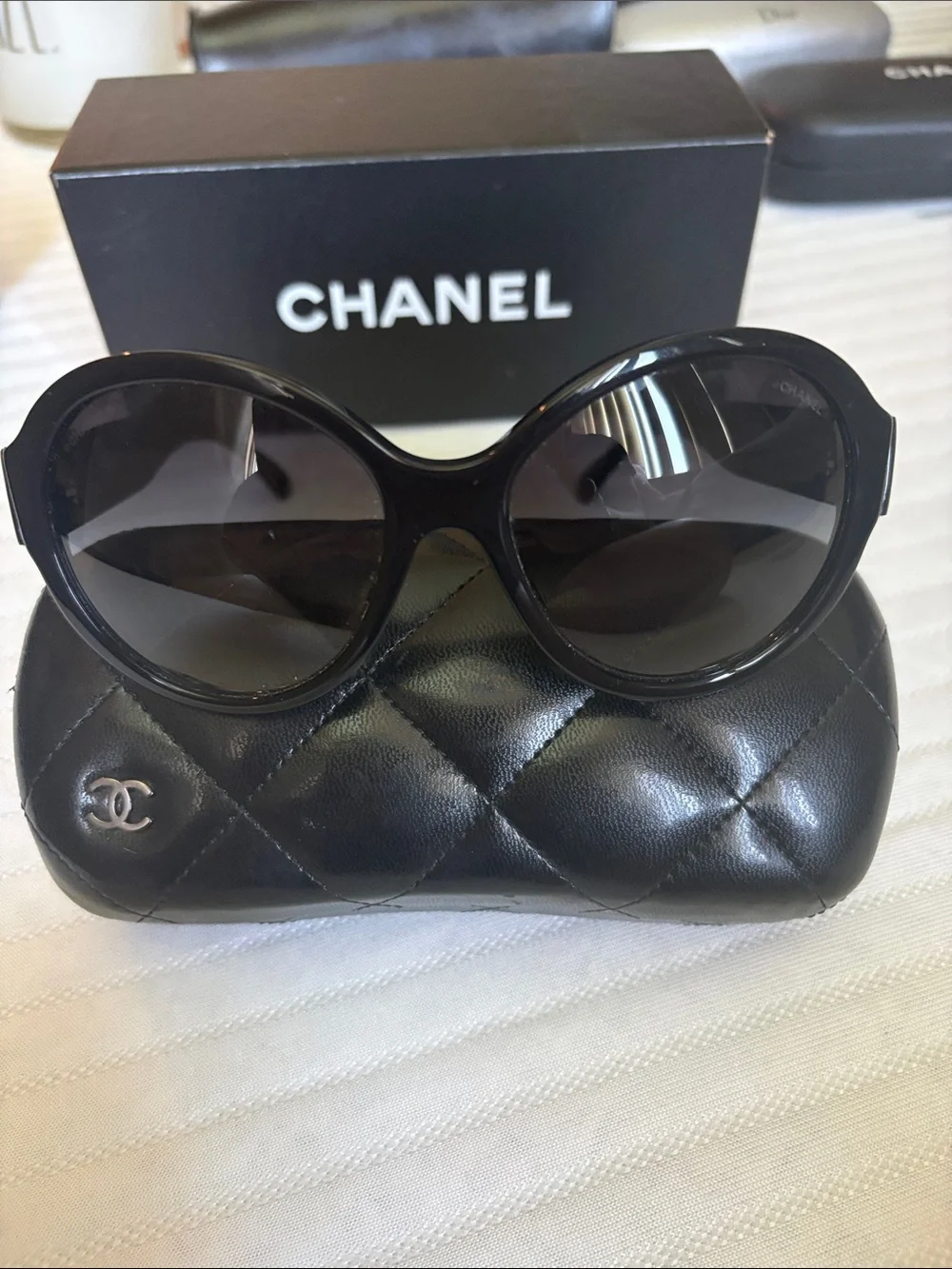 CHANEL Black Oversized Round Women's Sunglasses with iconic bows on each side.